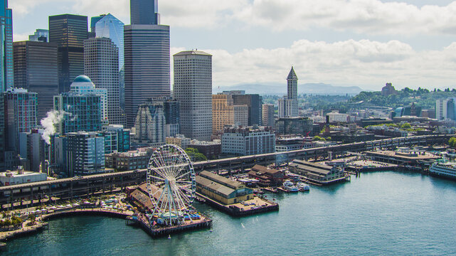 Seattle, Washington waterfront aerial drone view with the viaduct Alaskan Highway. Great Wheel to Smith Tower