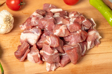 Diced cow meat. Fresh beef on a wooden floor. Close up