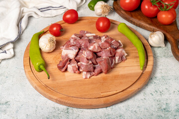 Diced cow meat. Fresh beef on a wooden floor