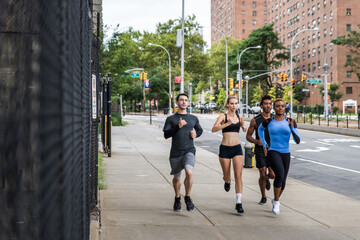 Group of urban runners running on the street in New york city, conceptual series about sport and fitness