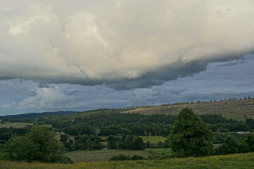 Storm clouds gather over lush farmland in the Highlands of Scotland. © Linda Harms