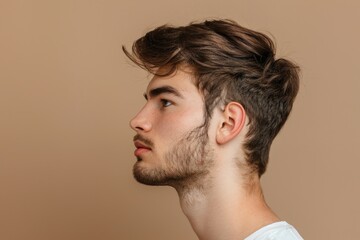 Obraz premium Young handsome man with bristle in profile photo pose