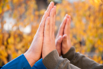 Give me five. Close up view of two successful men clapping their hands in the park