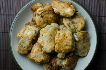 Pancakes with fish - traditional Lithuanian Christmas Eve dish, in the ceramic plate on the wooden table