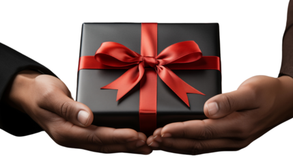 A close-up shot of hands presenting a black gift box tied with a bold red ribbon, symbolizing care, isolated on transparent background.