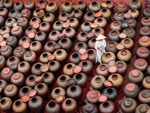 Vietnam country side worker filling soy sauce