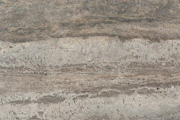 Unique gray stone surface with layered textures seen in natural light during daylight hours in an outdoor setting