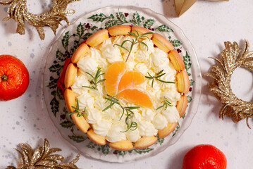 Mandarin Charlotte cake on a Christmas rustic background