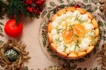 Mandarin Charlotte cake on a Christmas rustic background