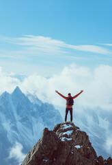 Hiker celebrating on mountain peak