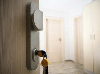 Keys inserted in a door lock, symbolizing security, access, and privacy in residential or...