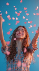 Naklejka premium A joyful young woman celebrating surrounded by heart shaped confetti in a serene outdoor setting