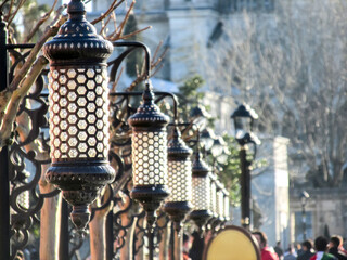 Ornate lanterns line the path near Sultanahmet Mosque in a serene setting.