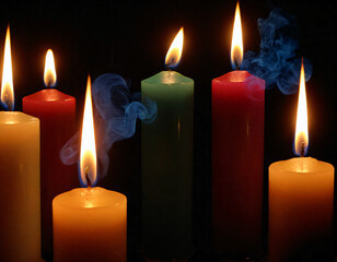 Romatized candles for meditation, colored smoke, on a black background.