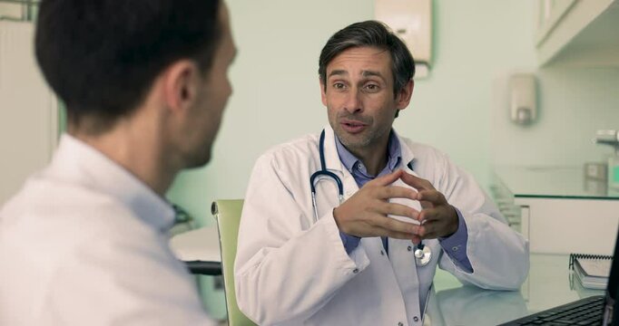 GP talk with clinic client in office, after discussing health condition, doctor and patient agree on comprehensive treatment plan, fostering sense of partnership, mutual respect with handshake gesture