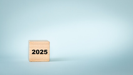 year 2025, date on wooden cube. Pastel blue background, copy space. Business concept. New year 2025, new opportunities