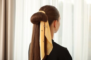Teenage girl with stylish bandana indoors, back view