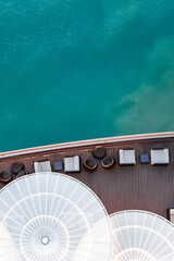 Top view of sea and water of sailing ship. Lounge promenade deck on cruise liner, vertical photo