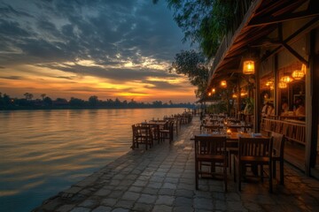 A serene restaurant scene on the shore of a lake during sunset, perfect for use in travel or outdoor lifestyle images