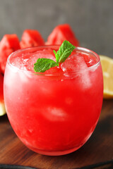 Tasty watermelon drink in glass on wooden table, closeup