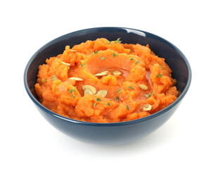 Tasty mashed sweet potato with pumpkin seeds and thyme in bowl isolated on white