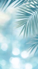 Soft green palm leaves against a blurred blue background in a tranquil tropical setting