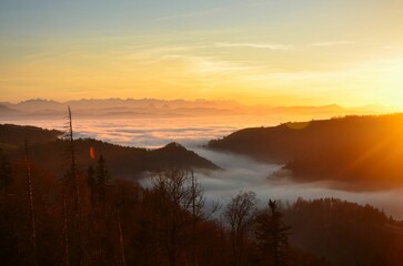 Beautiful sunset on the hill Schnebelhorn with a large sea of ​​fog. Small hill as an island in the fog. Autumn mood in the Zurich Oberland. High quality photo