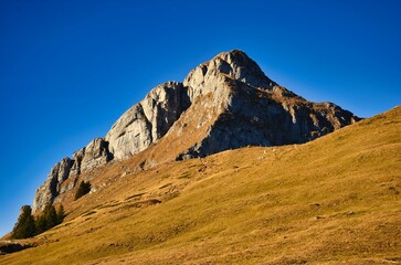 Mountain climbing in Glarus. Climb beautiful mountains outdoors in nature. Experience autumn mountain scenery in the Swiss Alps. High quality photo.