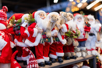 Vibrant collection of Saint Nicholas and Santa Claus figurines in elaborate red and gold costumes,...