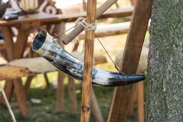Traditional horn made of animal horn on a wooden stand