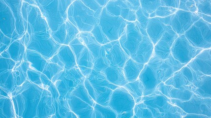 Obraz premium Shimmering blue water surface with ripples and reflections