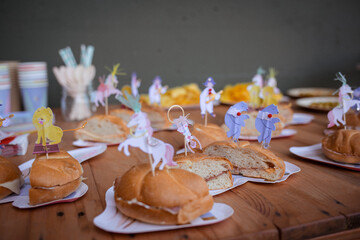 Sandwiches, snacks and desserts food served with some decoration in a birthday party