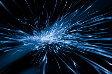 Fototapeta premium blue sparks from the grinder glowing in the dark