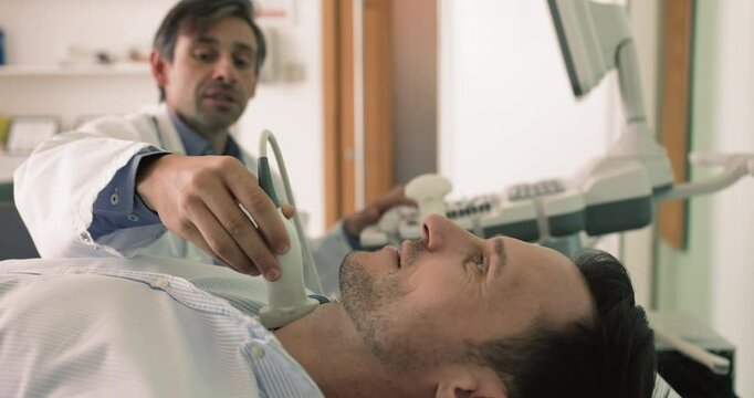Middle-aged male patient pass thyroid gland check-up, close up. Endocrinologist using ultrasound equipment, checking lymph nodes during client visit. Preventive medicine, endocrine system health-care