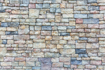 Obraz premium Vibrant Multicolored Brick Wall with Artistic Patterns