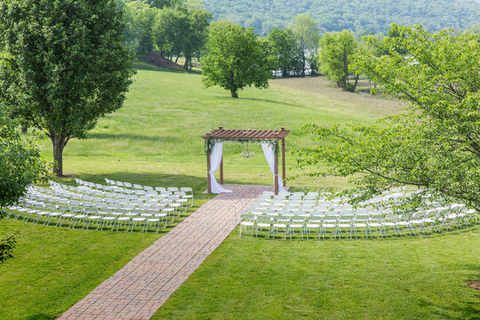 Elegant Outdoor Wedding Setup with Floral Decorations and Scenic Backdrop