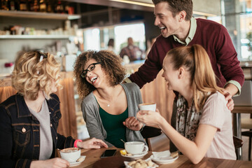 Group of young people enjoying a coffee in a cafe