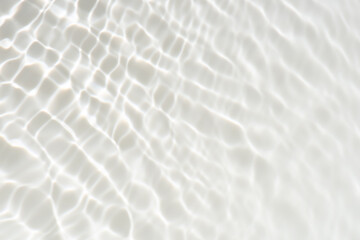 White water with ripples on the surface. Defocus blurred transparent white colored clear calm water surface texture with splashes and bubbles. Water waves with shining pattern texture background.