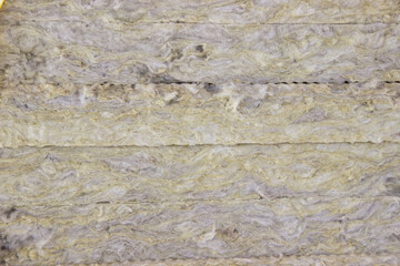 Close-up of mineral wool, insulation for walls, insulation from cold. Cozy warm house, savings, construction and repair concept
