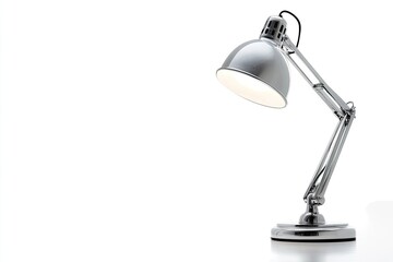 A modern, silver desk lamp illuminates a white background.