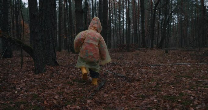 A lost child in a yellow raincoat runs through a dark forest, evoking a sense of fear and anxiety. The dense forests create an atmosphere of tension, emphasizing the danger of the child being lost.
