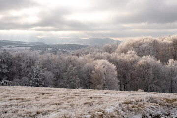 Sunset and first snow in a mountains in late autumn