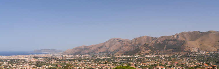 Panoramic view of Palermo city and mountains from Monreale town, Sicily, Italy, vast coastal cityscape framed by mountains in background, coastline and urban landscape