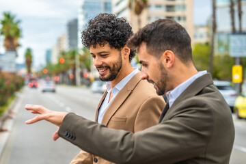 Businessmen talking while talking in the city