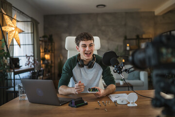 Young adult man record technology podcast in home studio setup