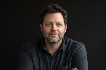 Portrait of a confident man with a warm smile and folded arms, exuding charisma, leadership, and professionalism, ideal for business, lifestyle, and motivational themes.