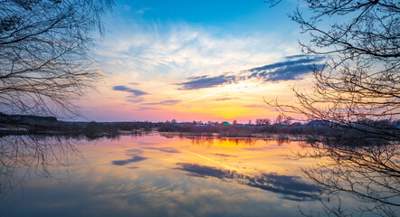 Beautiful sunset over a lake with a reflection of the sky in the water