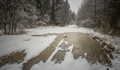 Snowy landscape with a body of water and the letters "h" and "f" in the snow