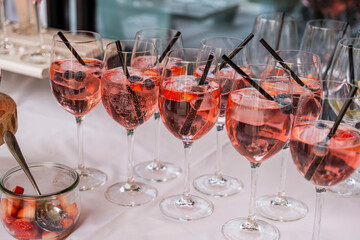 Glasses of wild berry sparkling wine drinks at a buffet at a wedding party