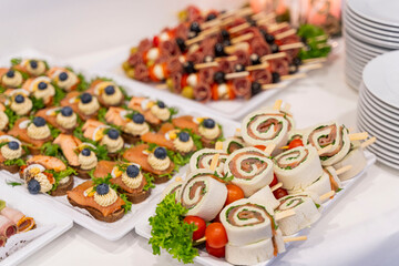 Various delicious canap&eacute;s are laid out on a table at a wedding ready for enjoyment